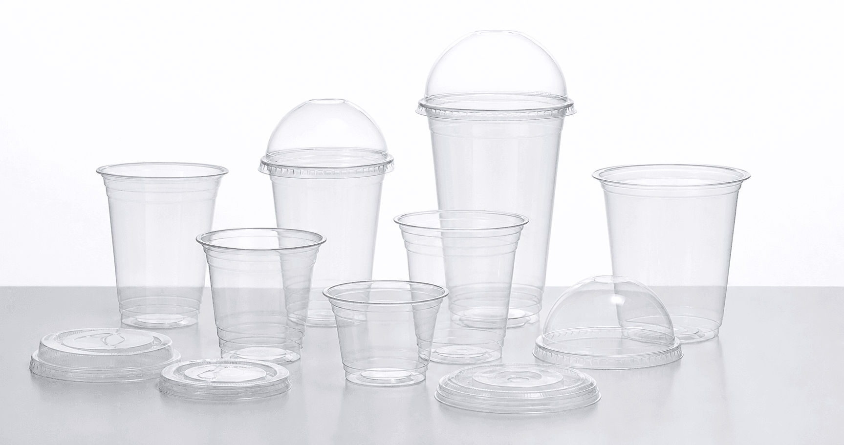 Clear PET cups and lids arranged for B2B product presentation